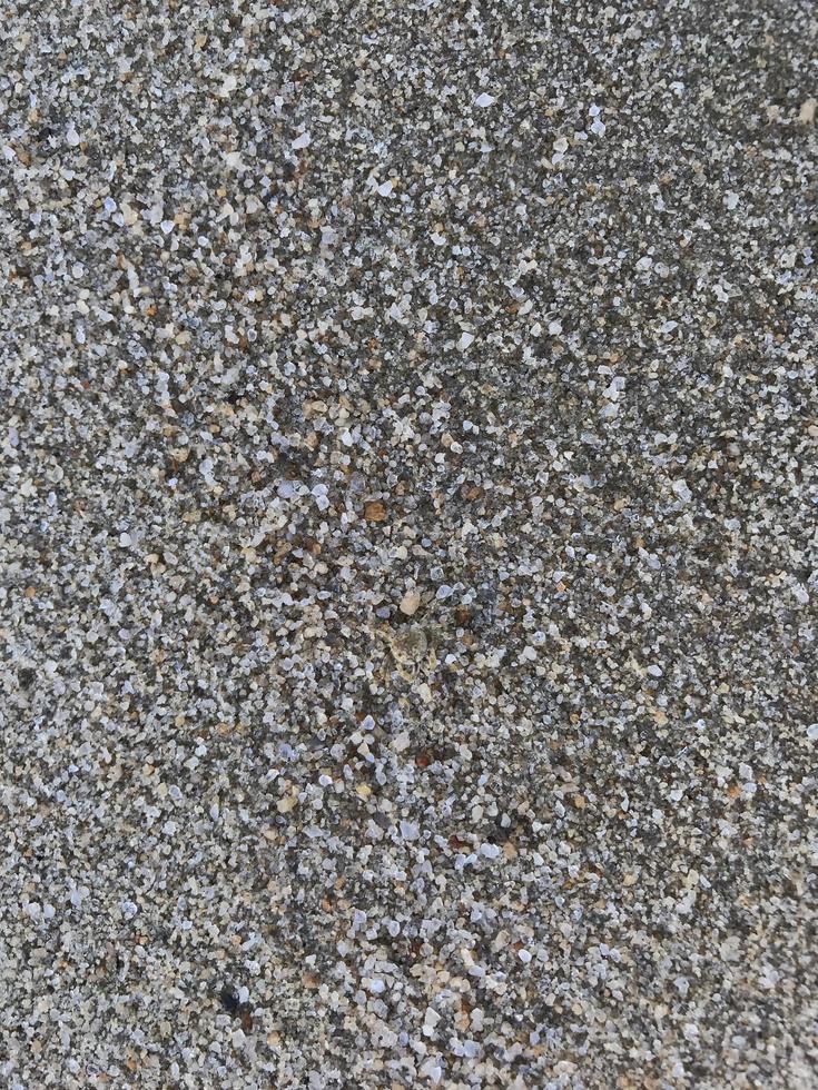 Questo è un' immagine di un' sfondo di sabbia su il spiaggia quello ha appena stato lavato lontano di il onde foto