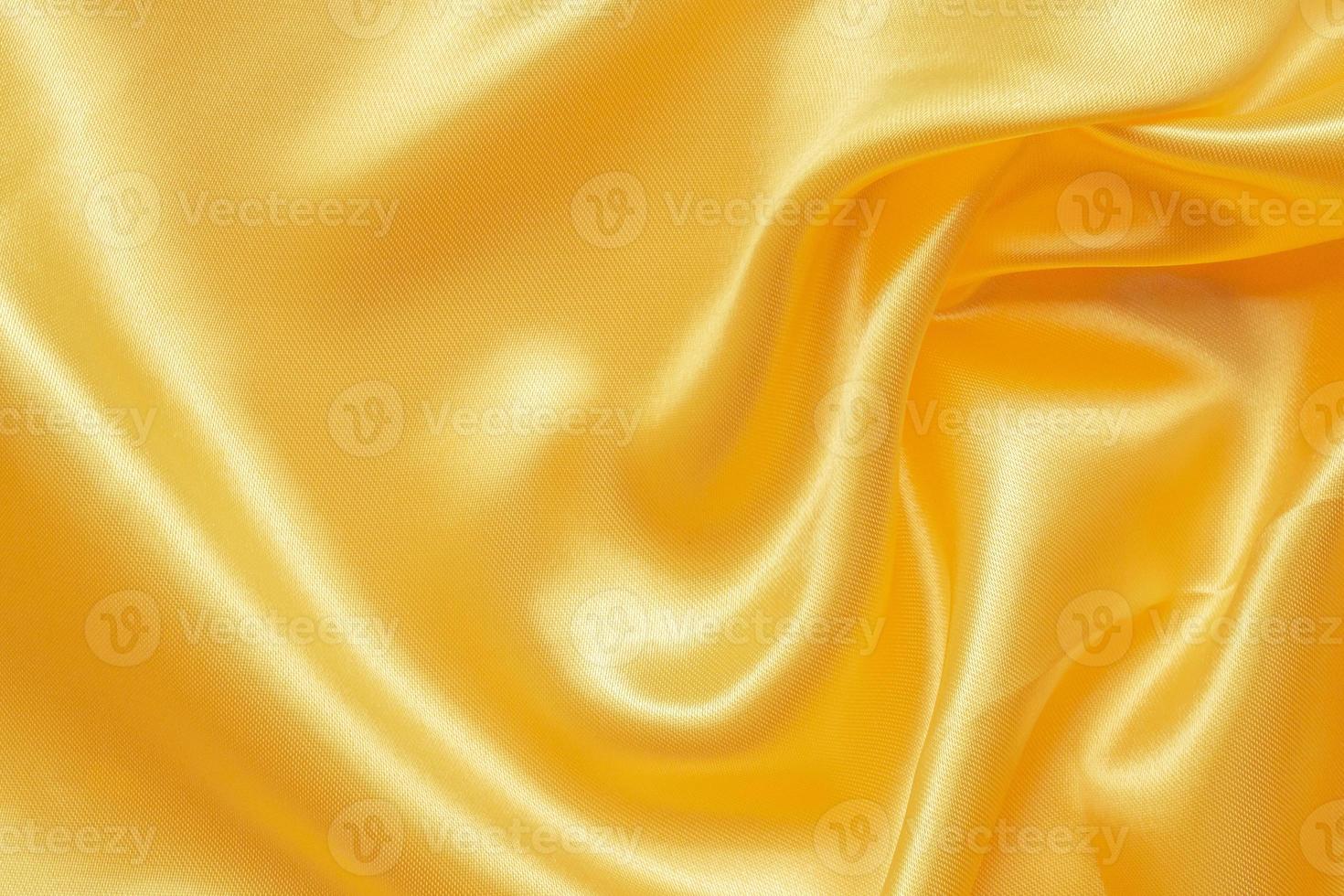 astratto lusso oro tessuto con morbido onda struttura sfondo foto
