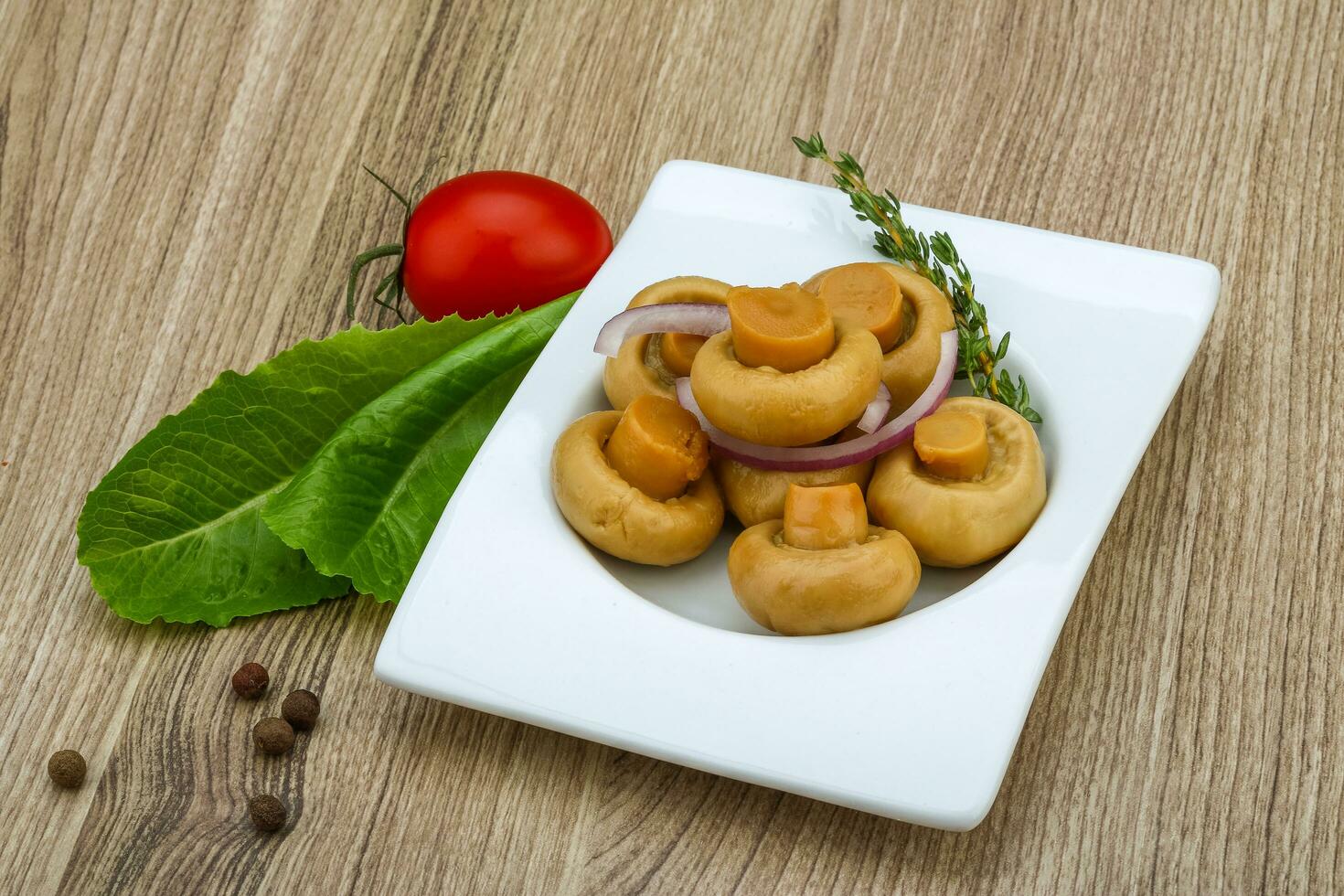 champignon sottaceto in una ciotola su fondo di legno foto