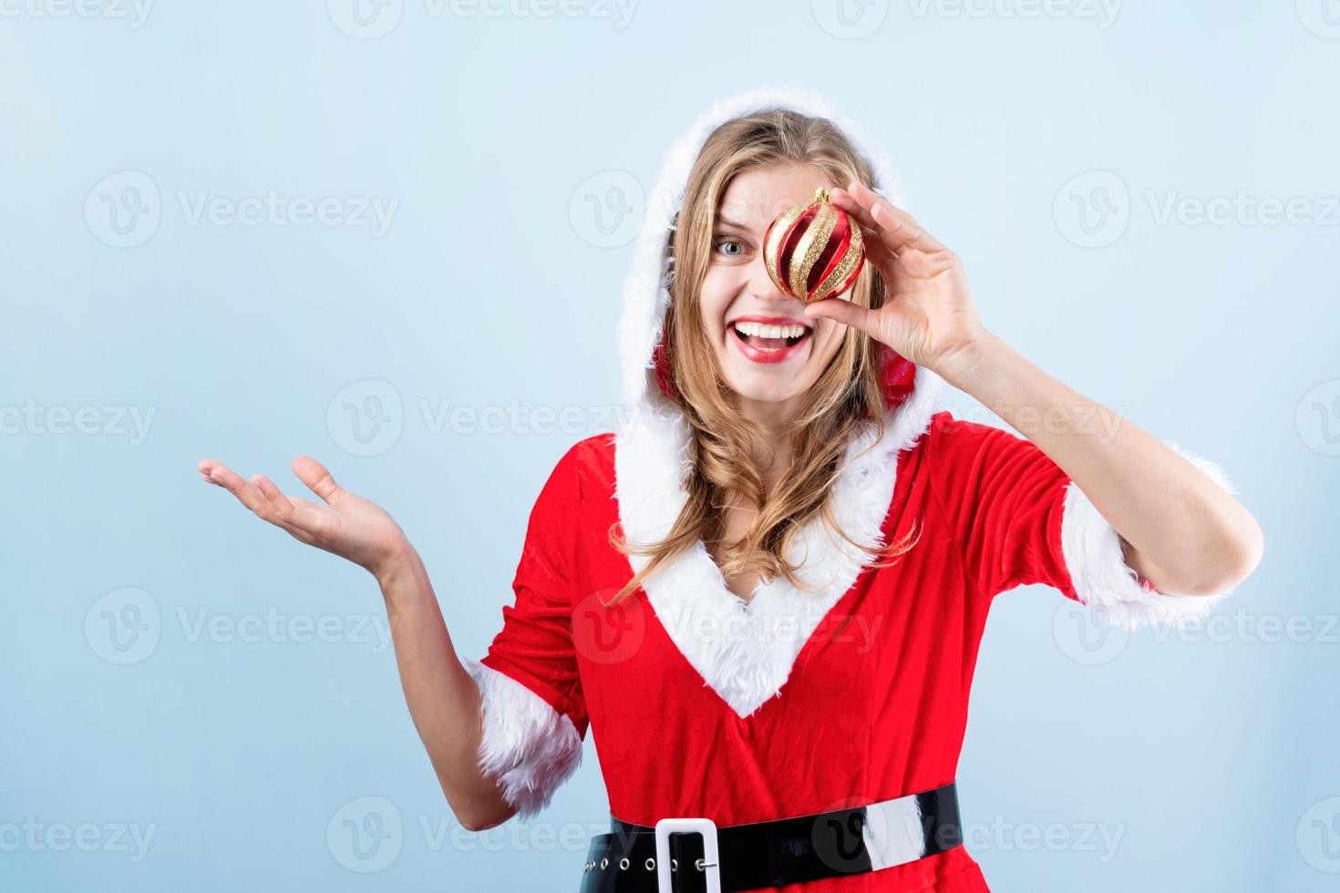 avvicinamento di caucasico contento donna indossare Santa Abiti ridendo Tenere Natale palla foto