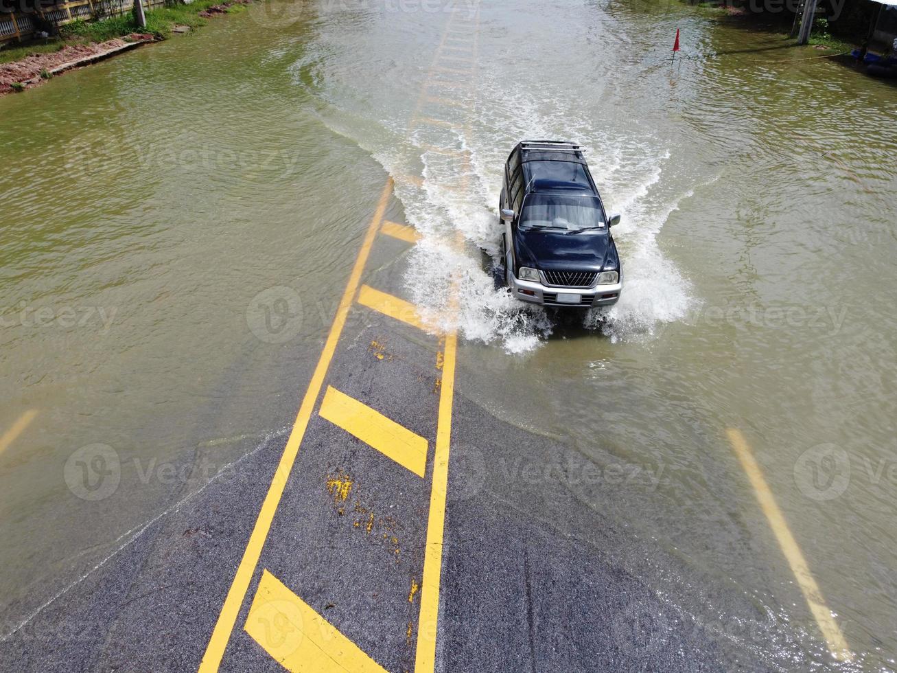 allagato strade, persone con macchine in esecuzione attraverso. aereo fuco fotografia Spettacoli strade allagamento e persone macchine passaggio di, spruzzi acqua. foto