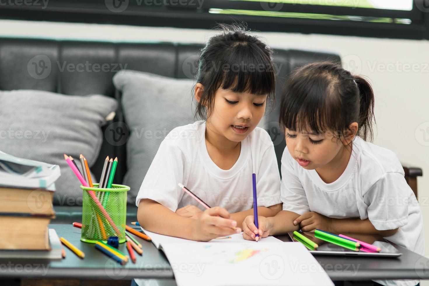 covid-19 coronavirus e apprendimento da casa, concetto di bambino a scuola a casa. i bambini piccoli studiano online imparando da casa con il laptop. foto