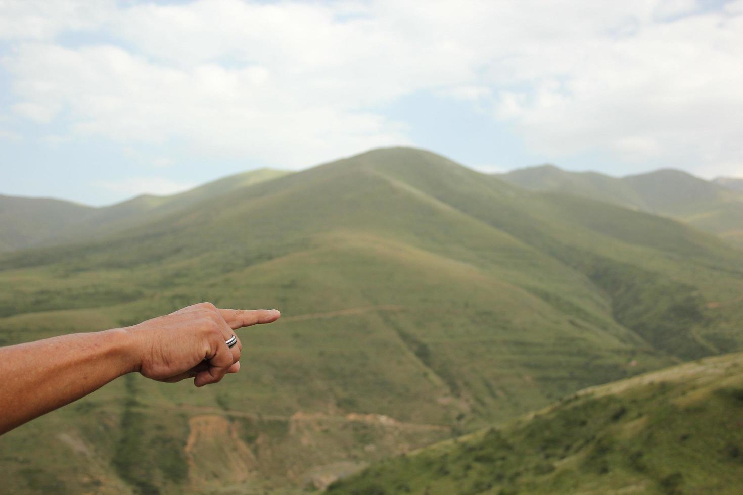 persona che punta il dito verso le montagne armene foto