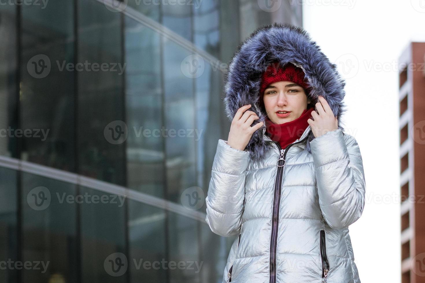 donna nel un' caldo giacca su il strada vicino il edificio foto