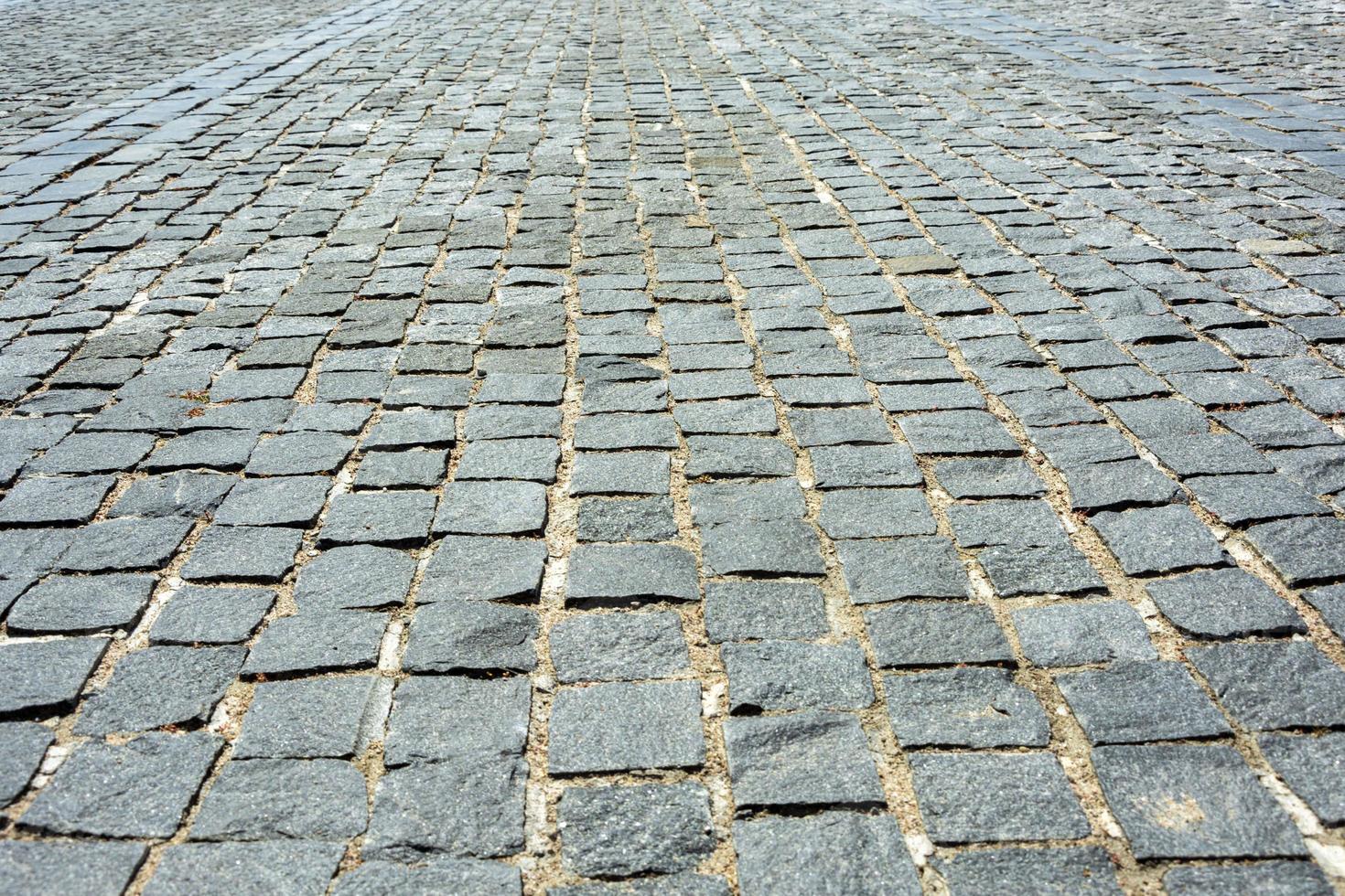 grigio vecchio ciottolo marciapiede, pavimentata piazze, piatto pietre foto