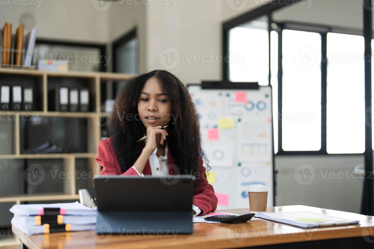 asiatico attività commerciale donna utilizzando calcolatrice e il computer portatile per fare matematica finanza su un ufficio scrivania, imposta, rapporto, contabilità, statistiche, e analitico ricerca concetto foto