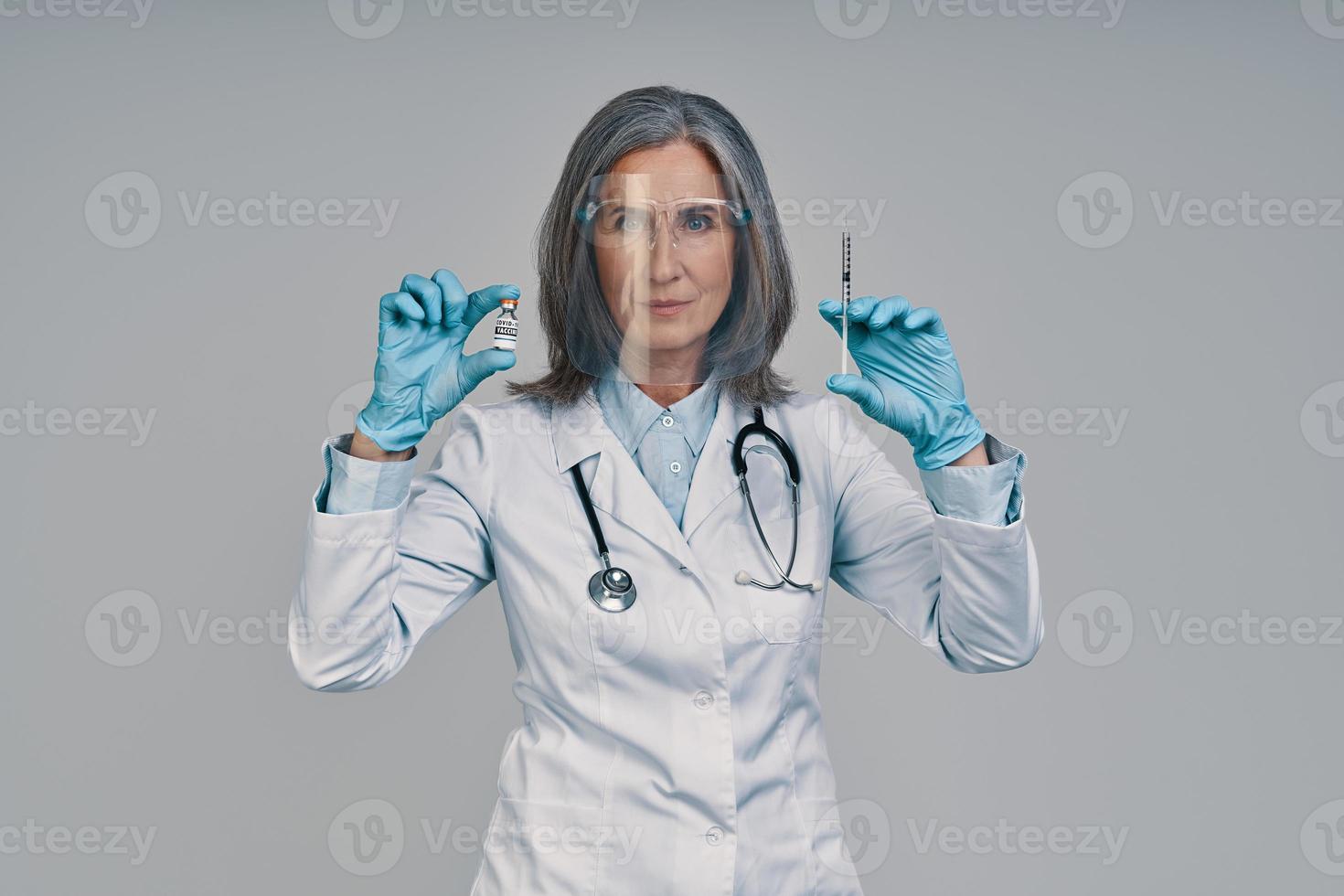 maturo bellissimo femmina medico nel viso scudo Tenere siringa foto