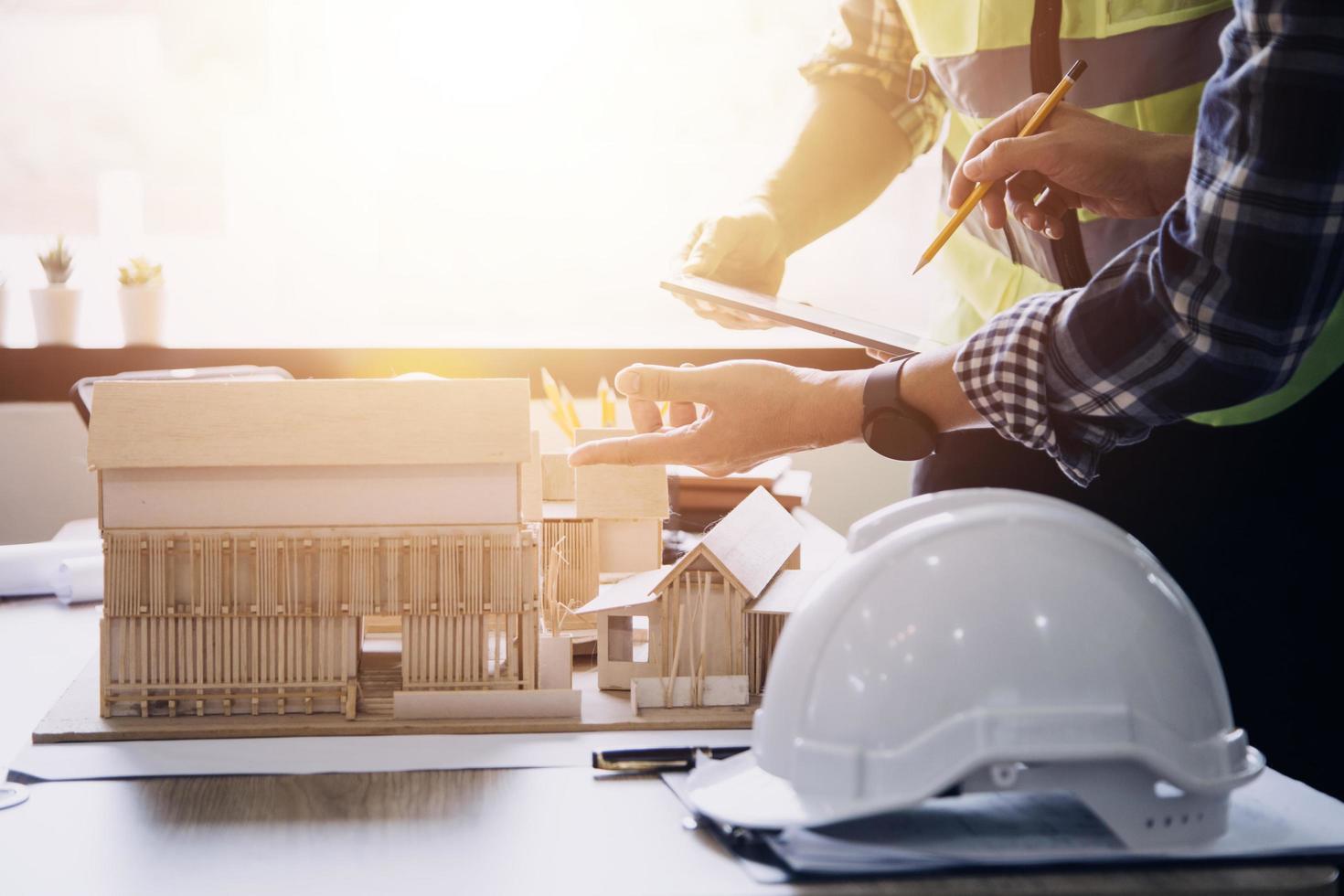 costruzione ingegnere Lavorando a planimetria per costruire grande commerciale edifici nel ufficio. ingegneria utensili e costruzione concetto. foto