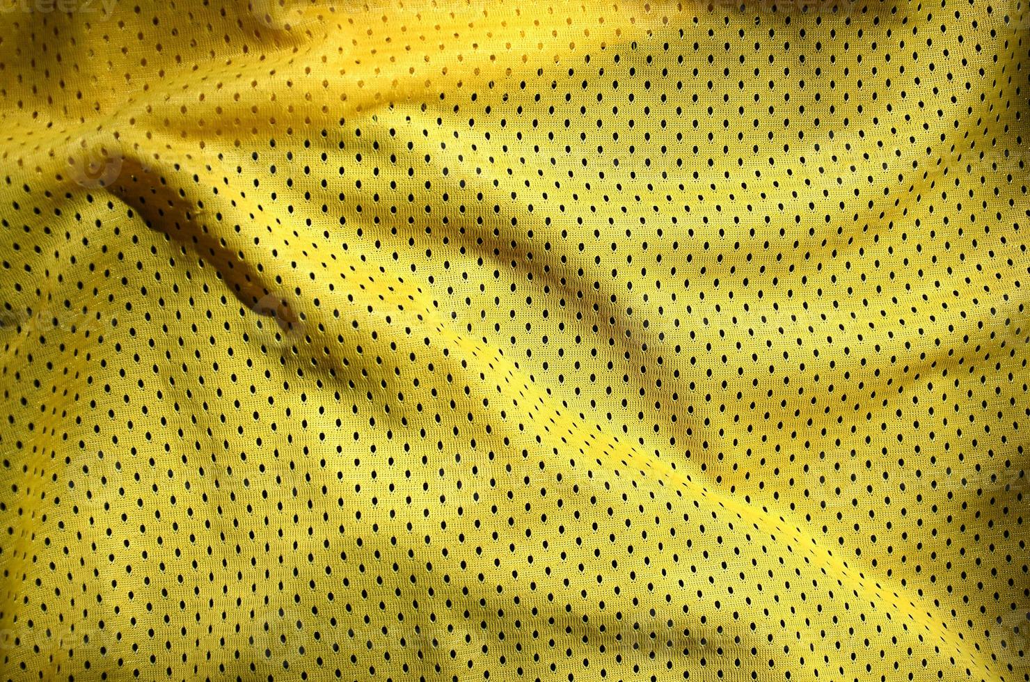 vicino su di giallo poliestere nylon abbigliamento sportivo pantaloncini per creato un' strutturato sfondo foto