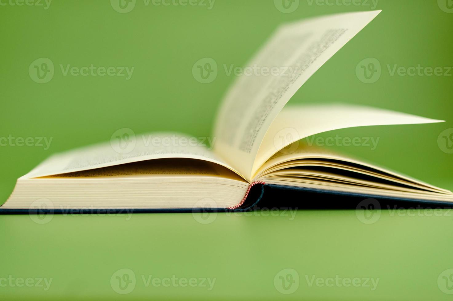 Aperto libro su verde sfondo lettura concetto foto