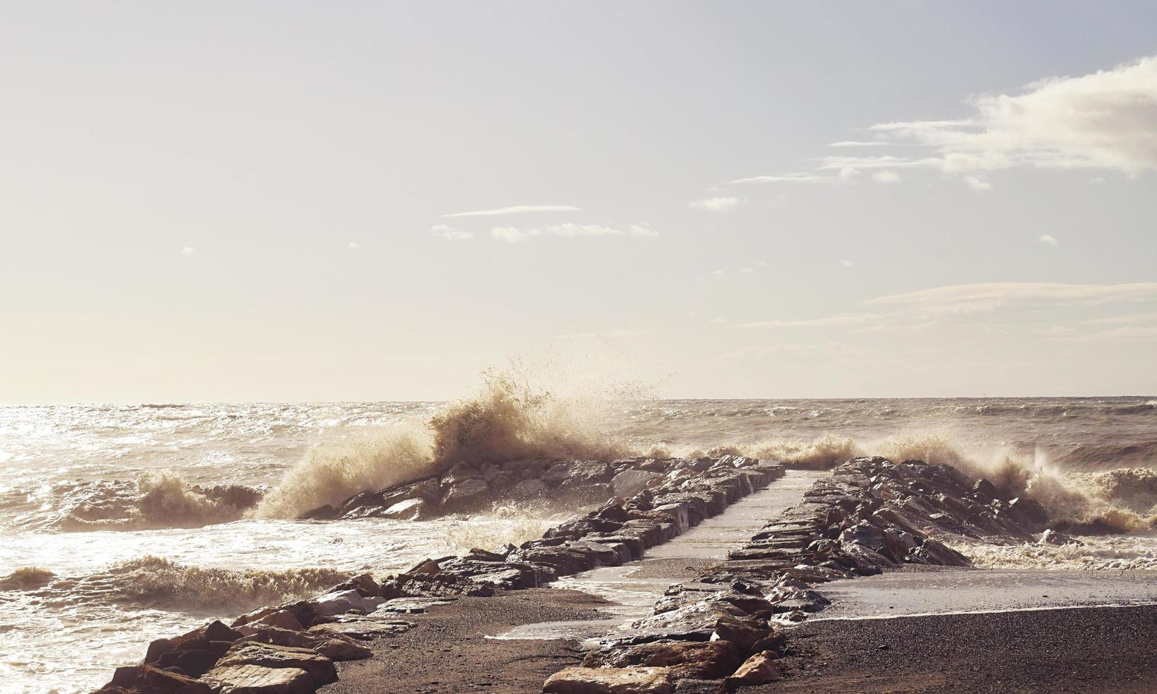 onde che si infrangono sul molo dell'oceano foto