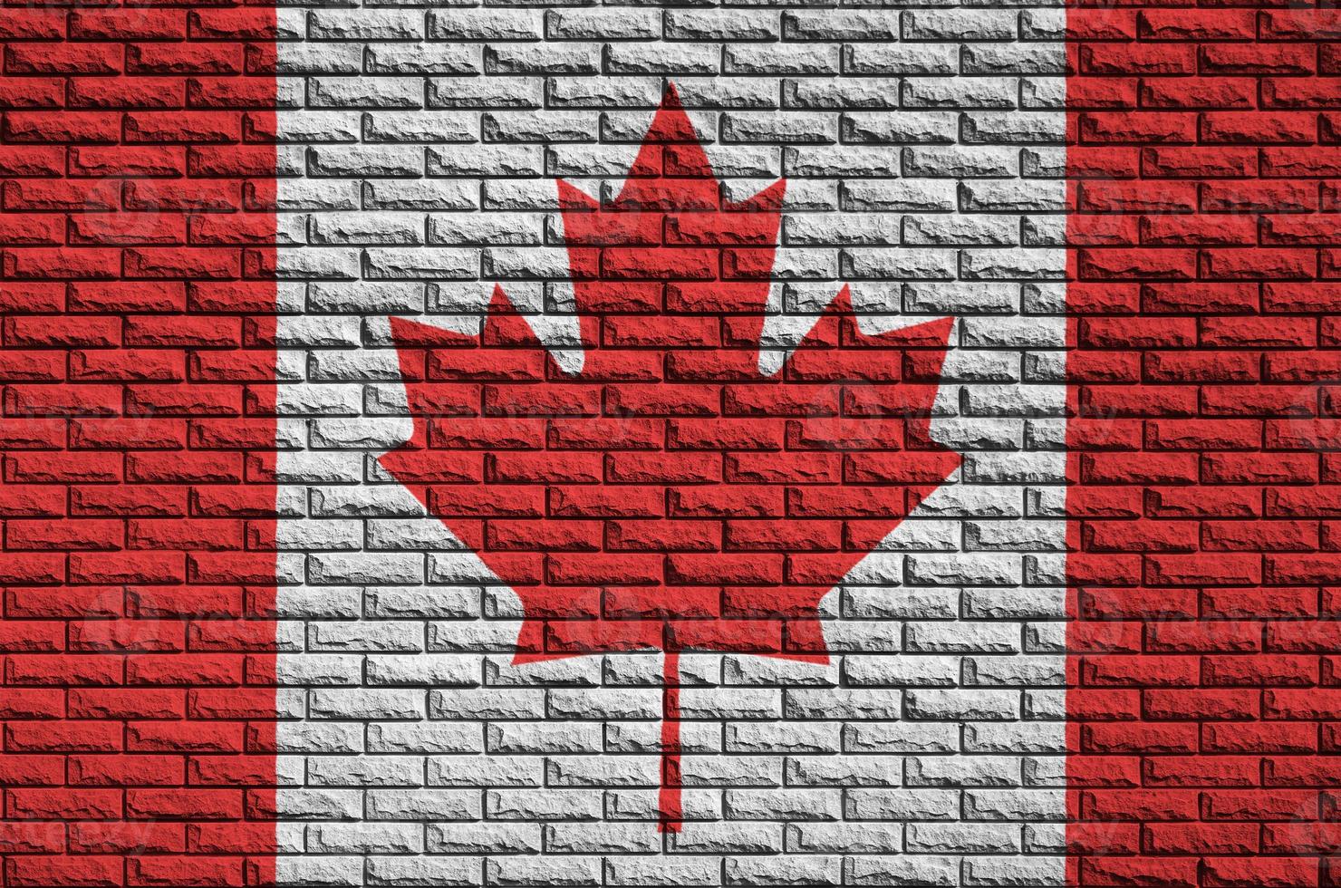 Canada bandiera è dipinto su un vecchio mattone parete foto