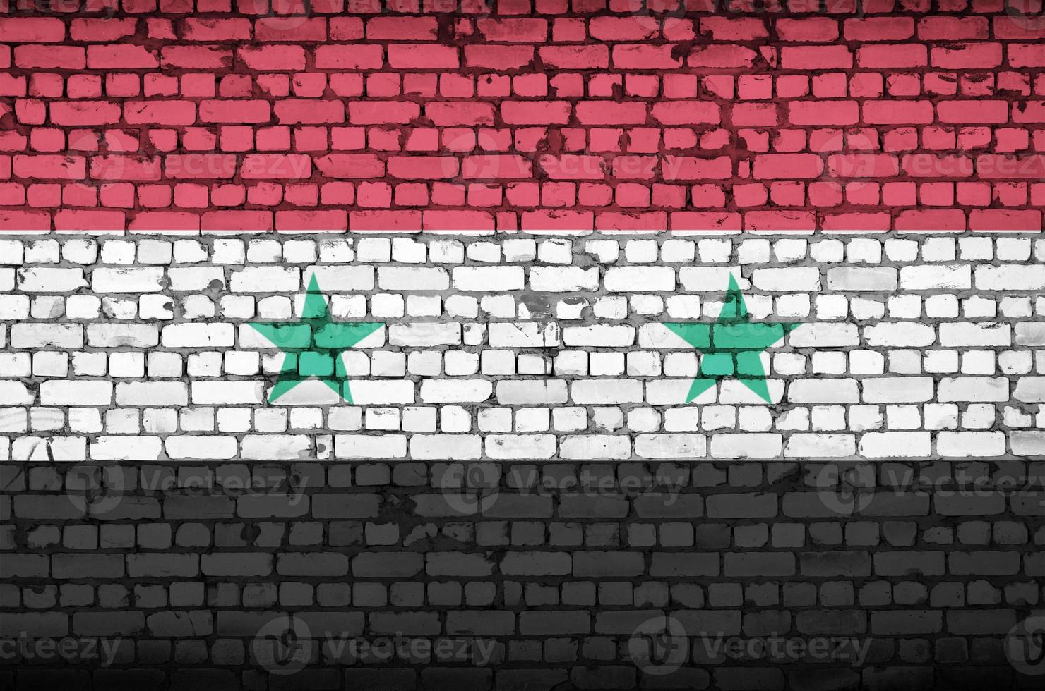Siria bandiera è dipinto su un vecchio mattone parete foto