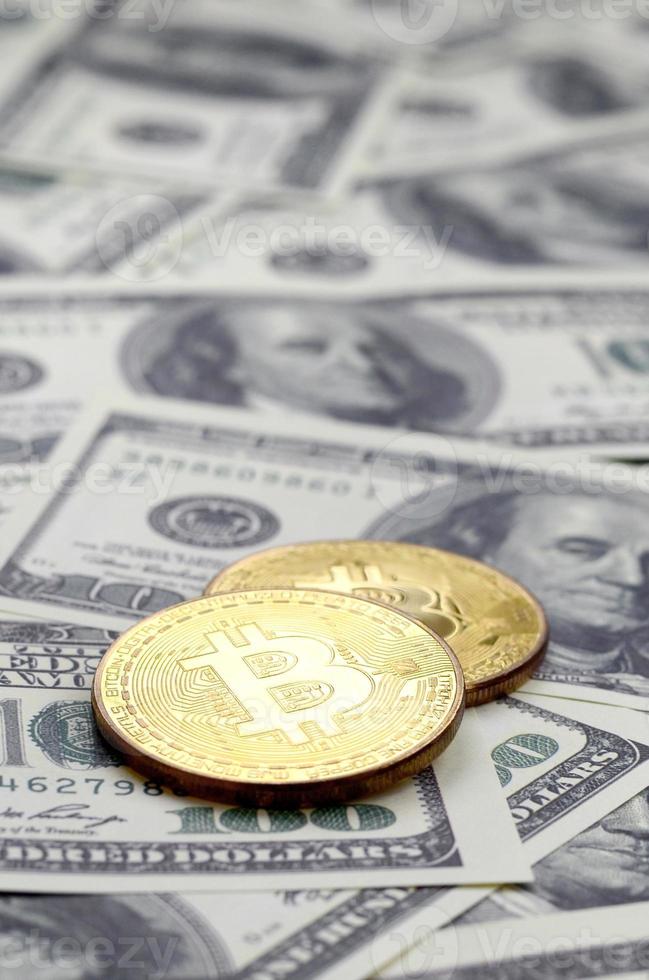 d'oro bitcoin menzogna su un' lotto di dollaro fatture. il concetto di raccolta il prezzo di bitcoin parente per il noi dollaro foto