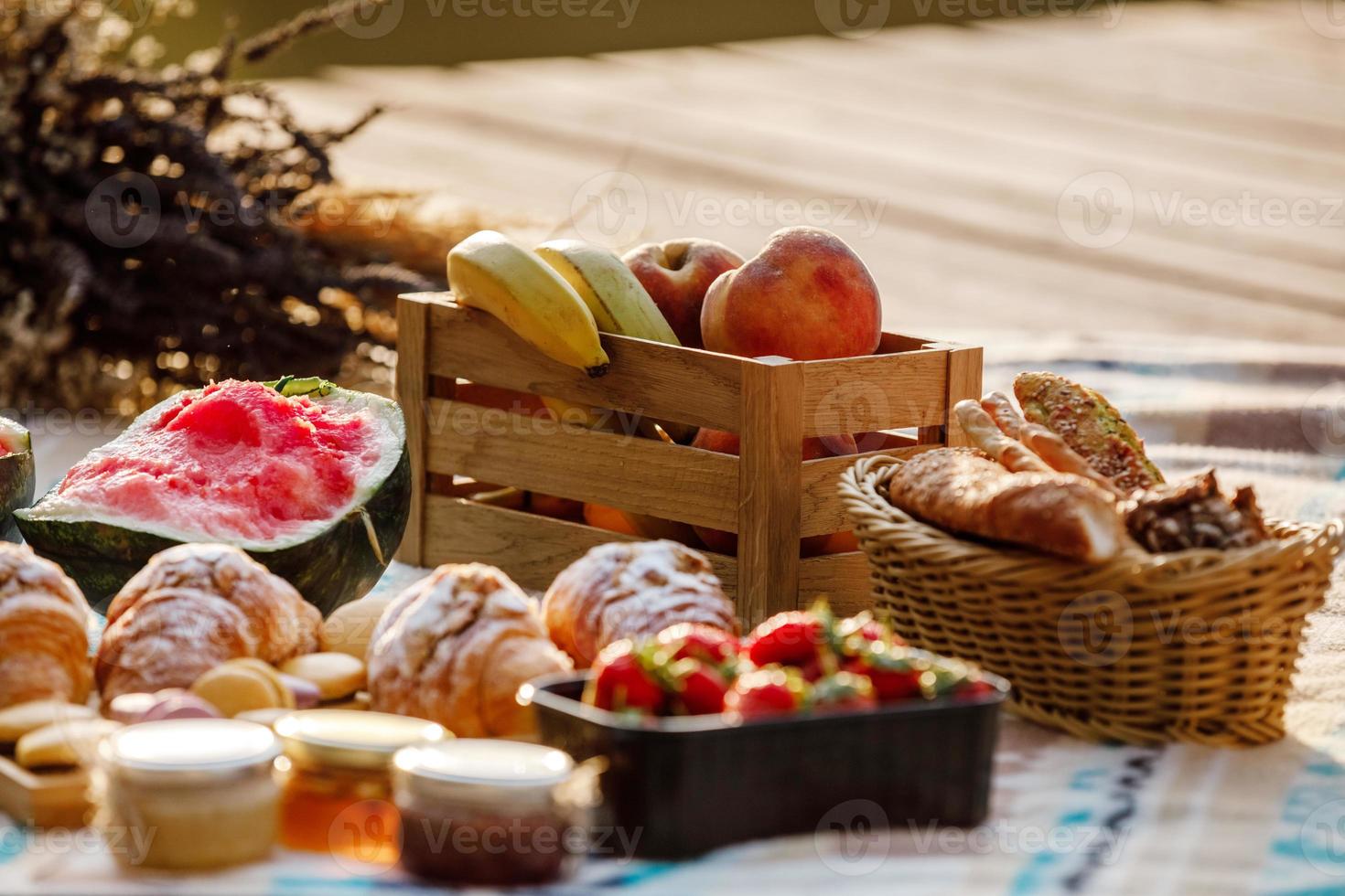 pic-nic al parco. frutta fresca, bibite frizzanti ghiacciate e croissant in una calda giornata estiva. pranzo al sacco. messa a fuoco selettiva foto