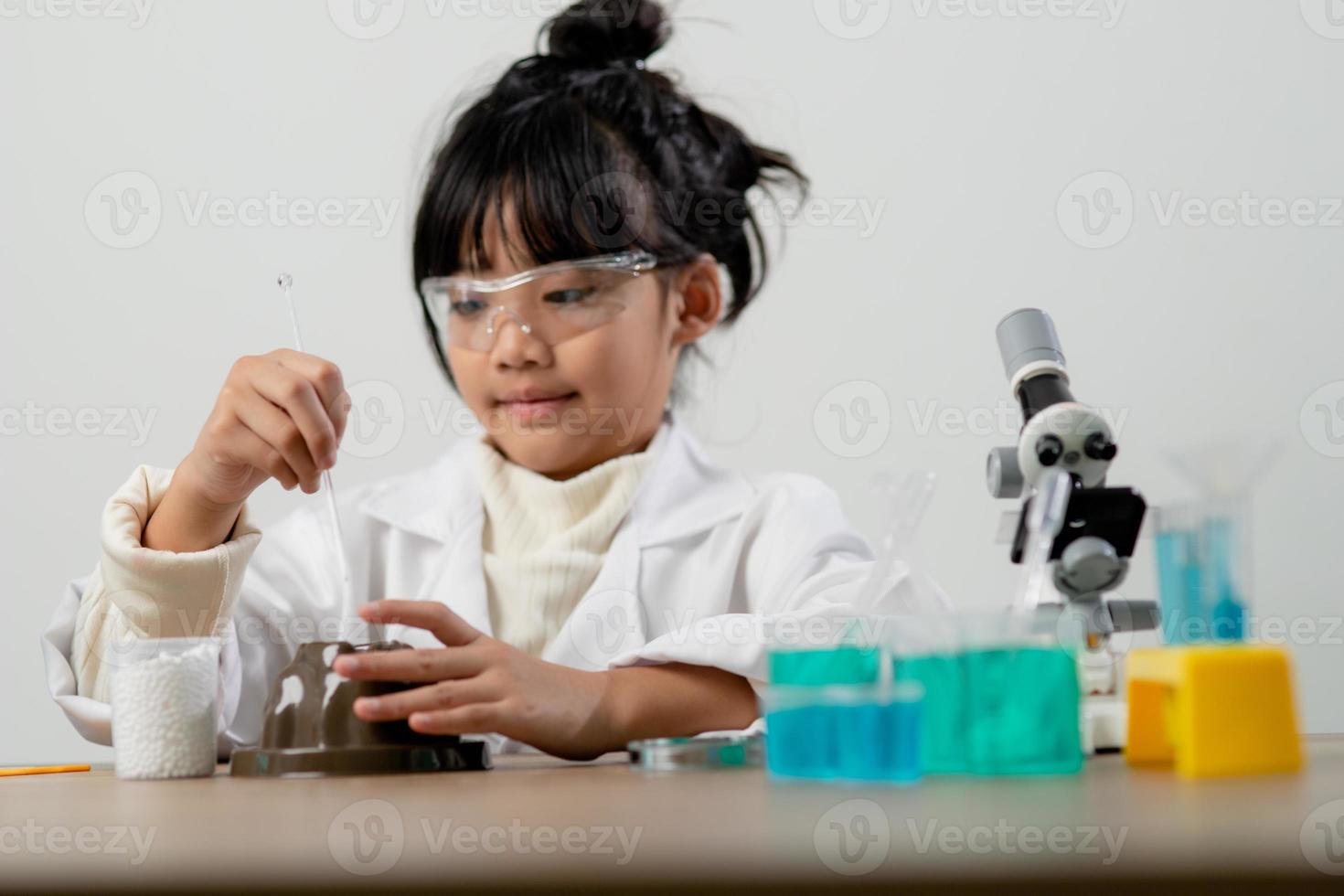 formazione scolastica, scienza, chimica e bambini concetto - bambini o studenti con test tubo fabbricazione sperimentare a scuola laboratorio foto