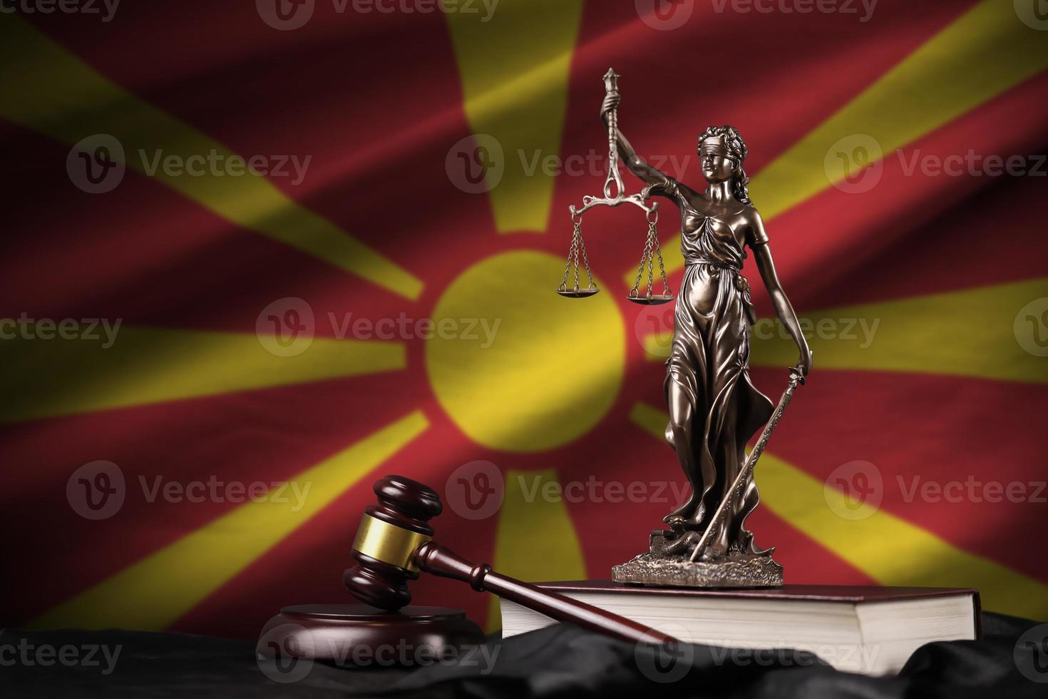 macedonia bandiera con statua di signora giustizia, costituzione e giudice martello su nero drappeggio. concetto di giudizio e colpa foto