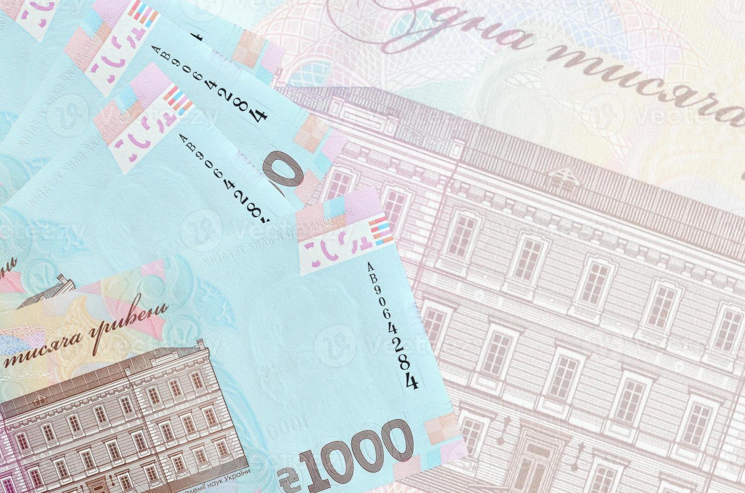 1000 ucraino grivna fatture bugie nel pila su sfondo di grande semi trasparente banconota. astratto attività commerciale sfondo foto