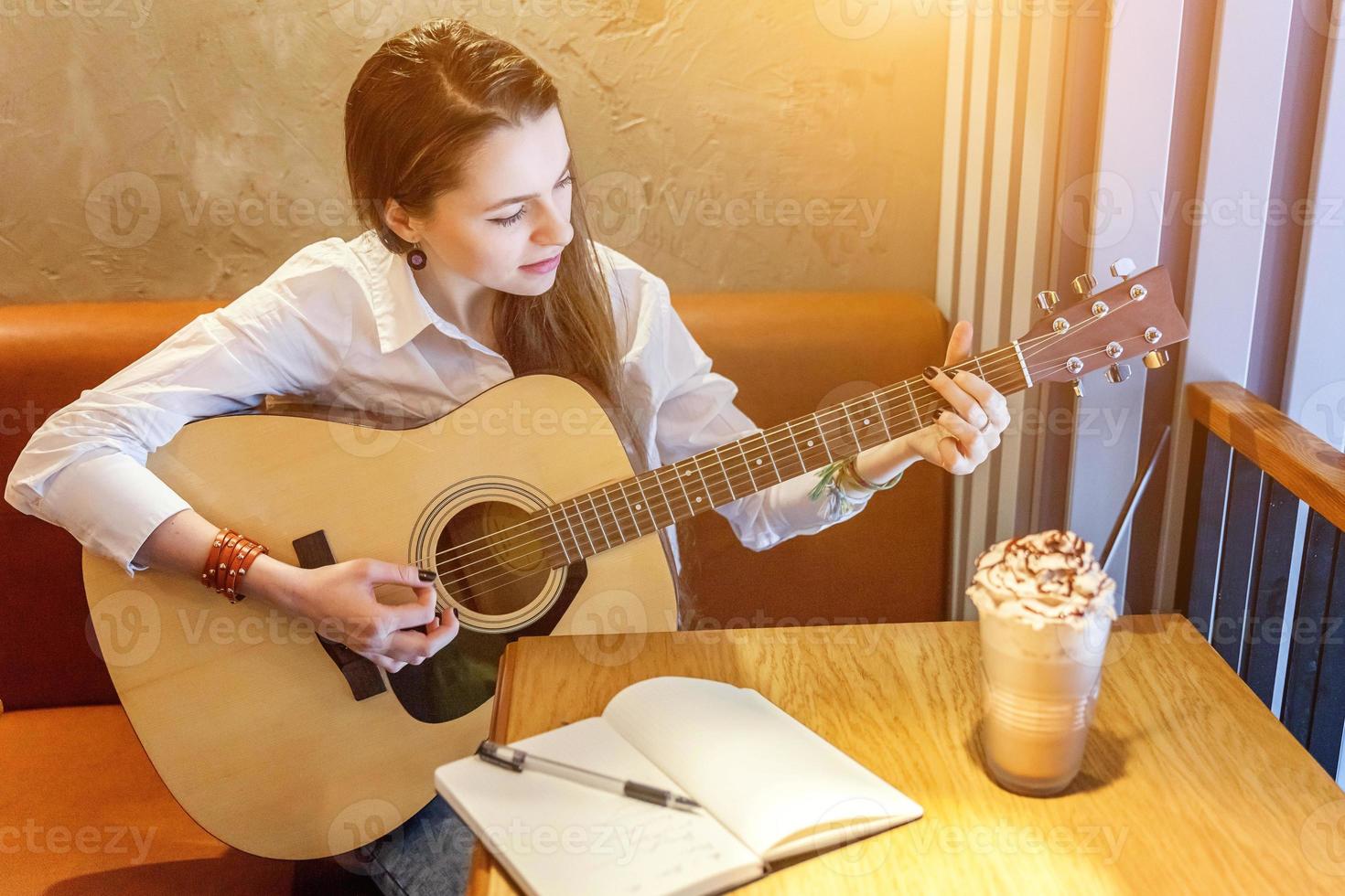 giovane ragazza giocando chitarra nel bar foto