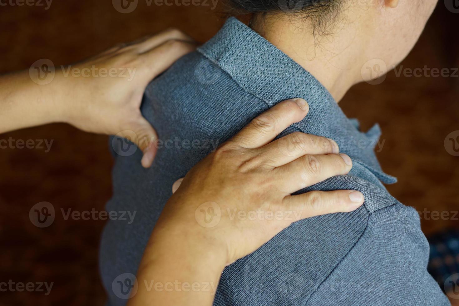 avvicinamento mani massaggio donna di le spalle. concetto, assistenza sanitaria. anziano Salute problema, mal di schiena e spalla dolore. massaggio per sollievo sindrome. corpo terapia trattamento. fisioterapia. foto