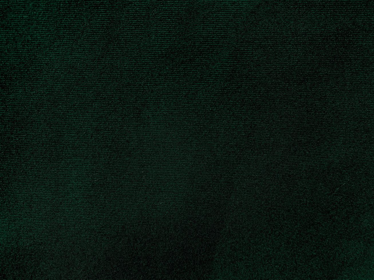 buio verde vecchio velluto tessuto struttura Usato come sfondo. vuoto verde tessuto sfondo di morbido e liscio tessile Materiale. Là è spazio per testo. foto