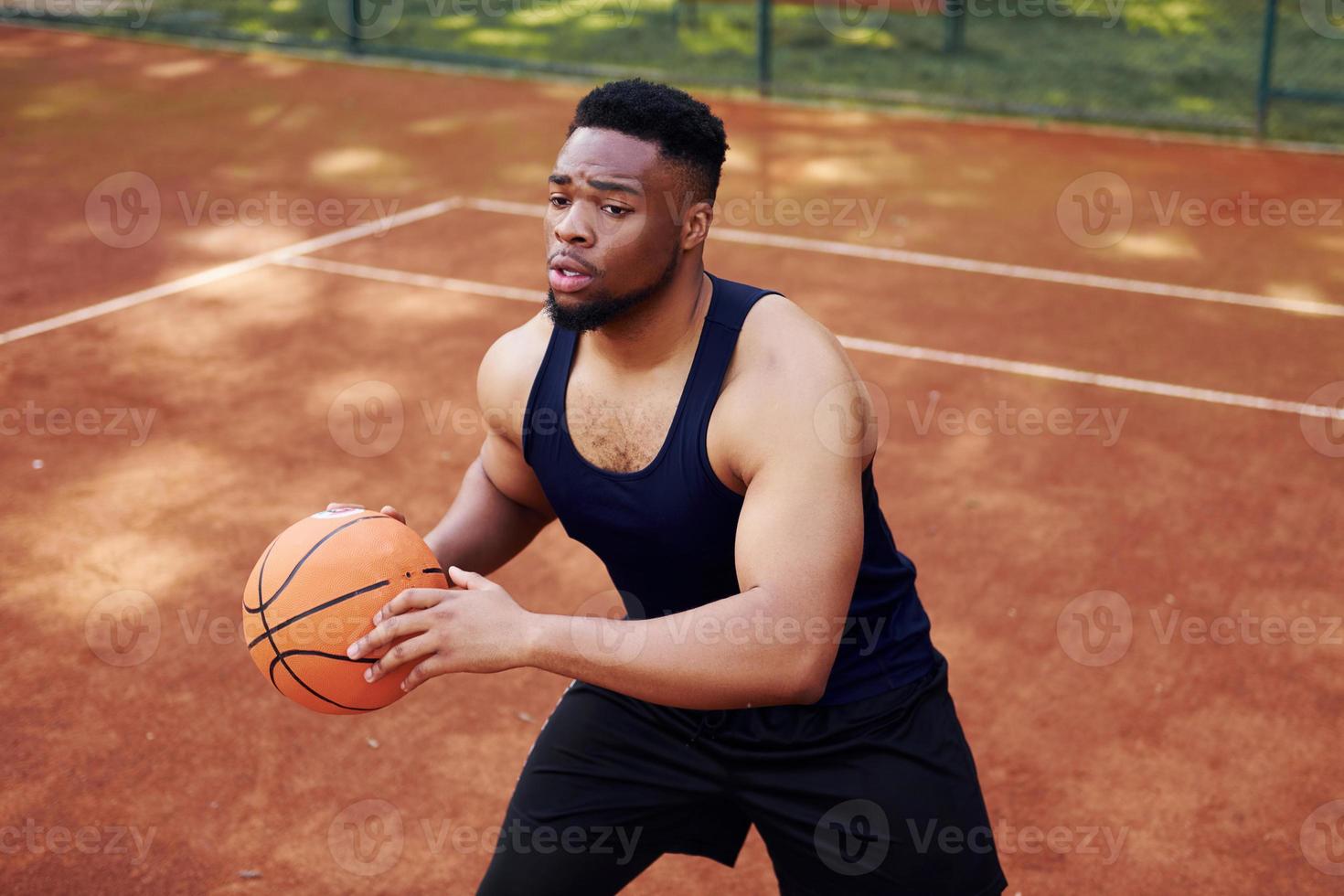 africano americano uomo giochi pallacanestro su il Tribunale all'aperto foto