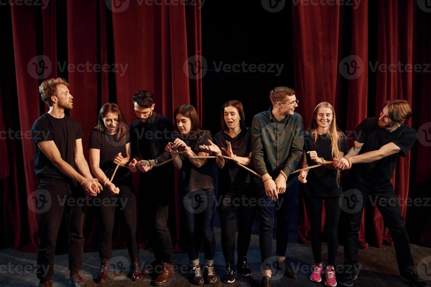 con corda nel mani. gruppo di attori nel buio colorato Abiti su prova nel il Teatro foto