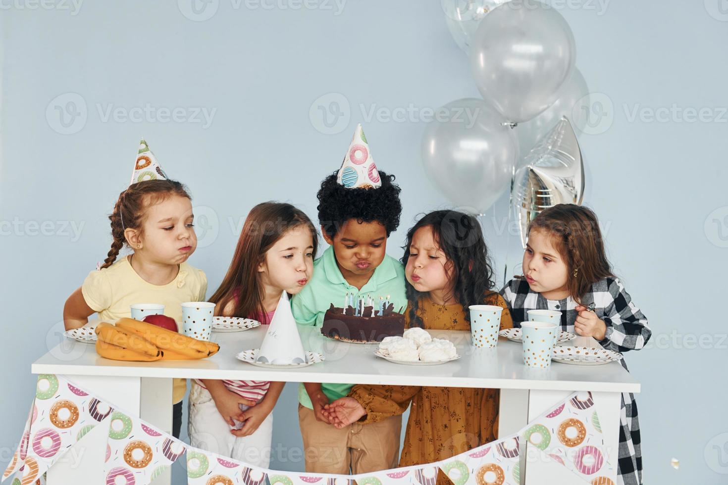 si siede di il tavolo. bambini su festeggiare compleanno festa in casa avere divertimento insieme foto