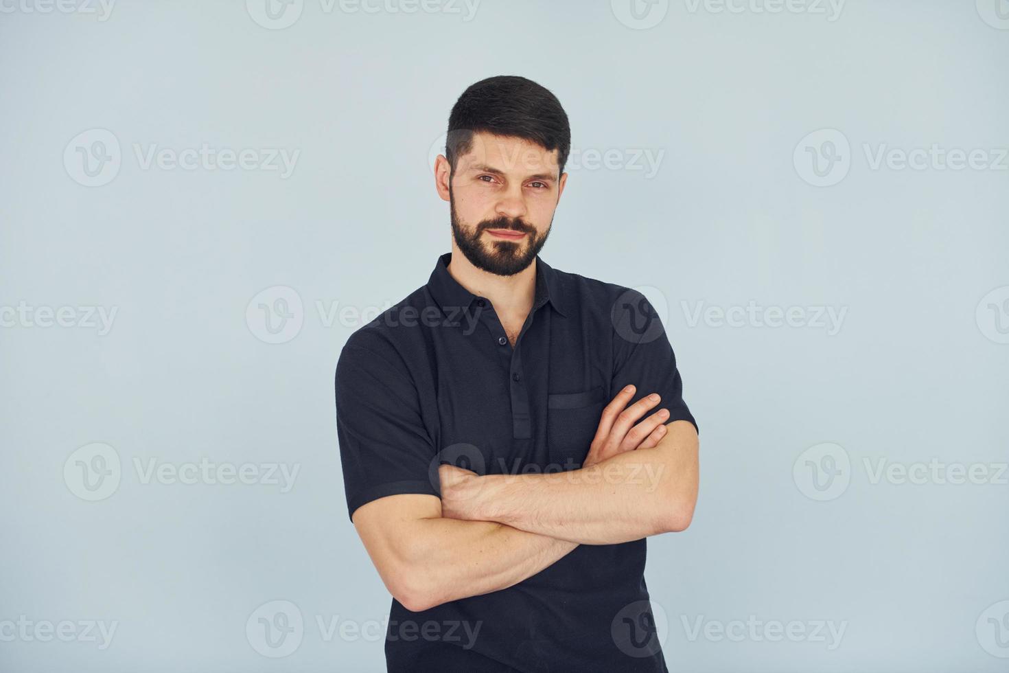 grave uomo nel camicia in piedi in casa contro bianca sfondo foto