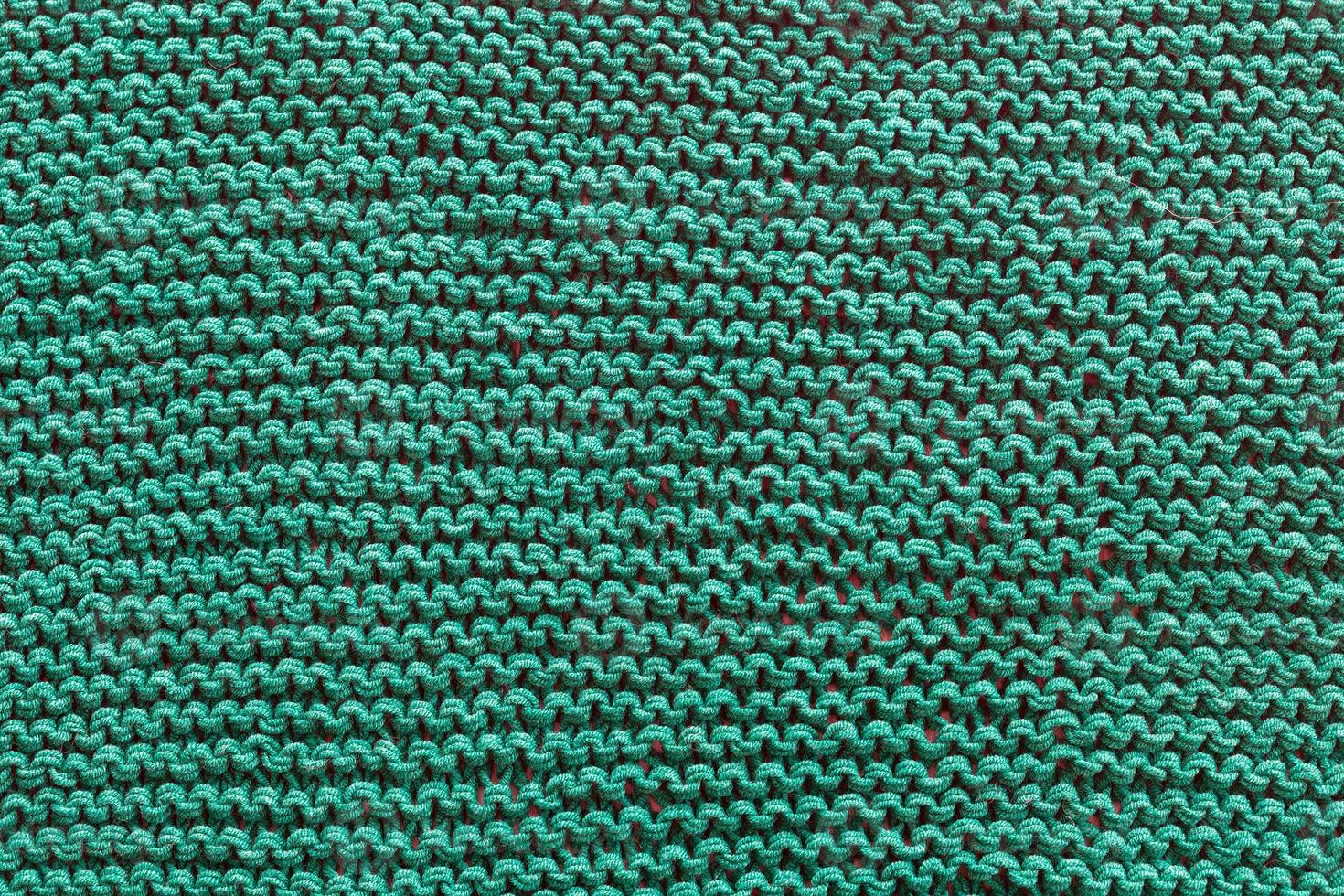 un' avvicinamento di un' verde a maglia maglione. foto
