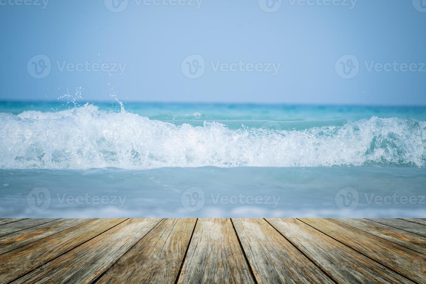 legna pavimento primo piano su orizzonte tropicale onda acqua sabbioso spiaggia. sfocatura blu mare sfondo con rilassante estate vacanza con Alba sole illuminazione Visualizza ponte toccante luce del sole, cielo Surf estate nuvole. foto