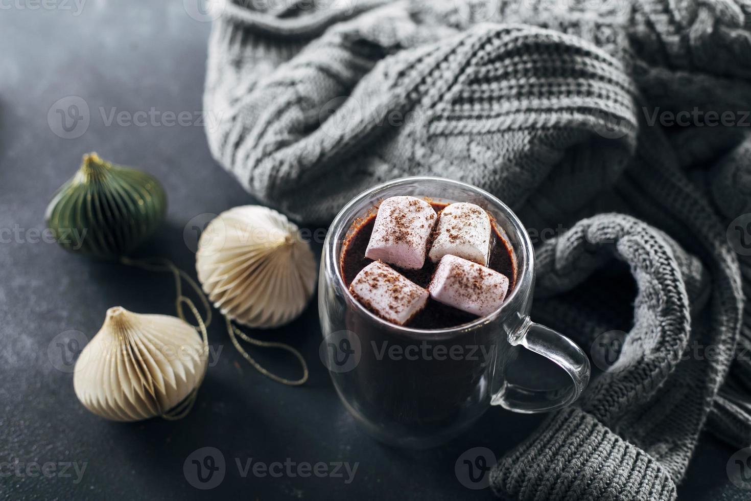 bicchiere con caldo cioccolato con marshmallow su buio blu sfondo foto