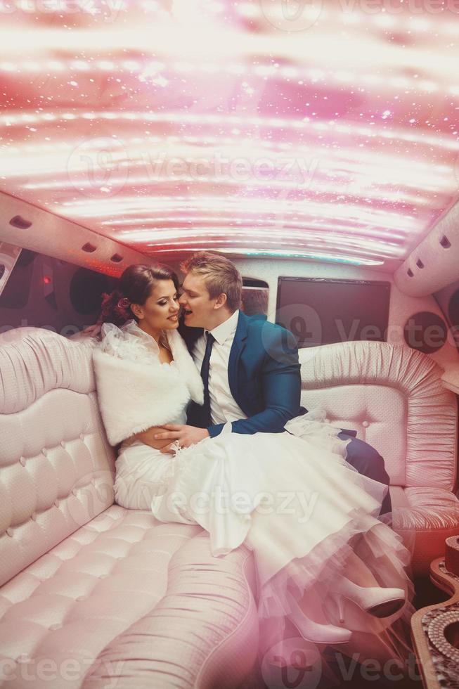 sexy bello uomo e donna appena si è sposato guida nel limousine foto