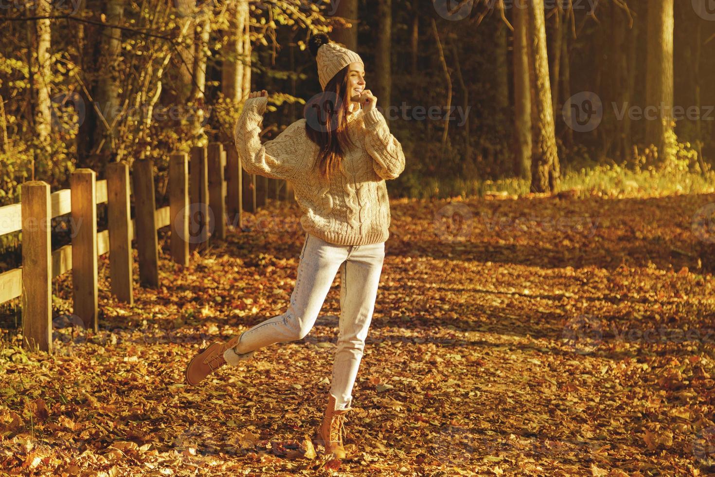 giovane e contento donna nel il parco a soleggiato autunno giorno foto