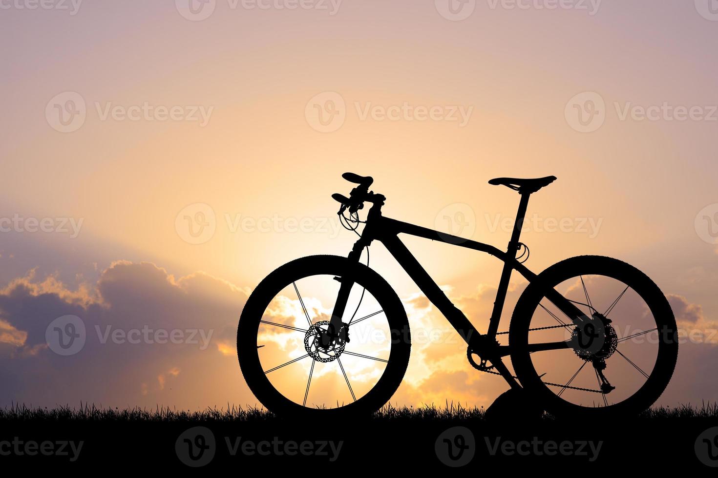 silhouette di un' bicicletta su tramonto foto