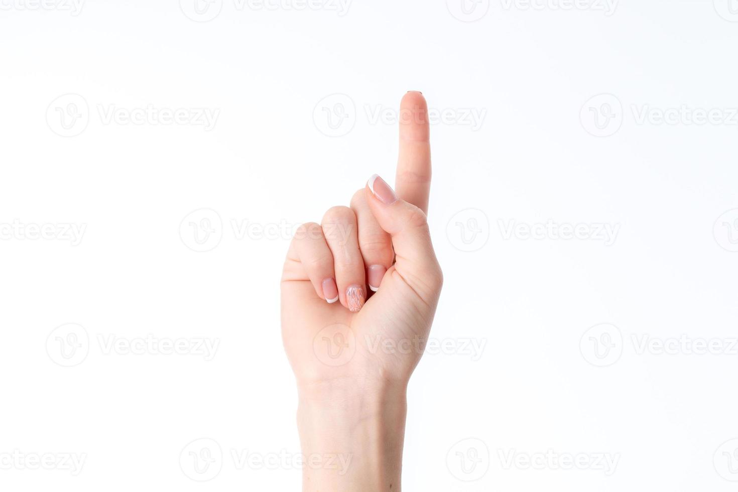 femmina mano mostrando il gesto con sollevato su uno dito isolato su bianca sfondo foto