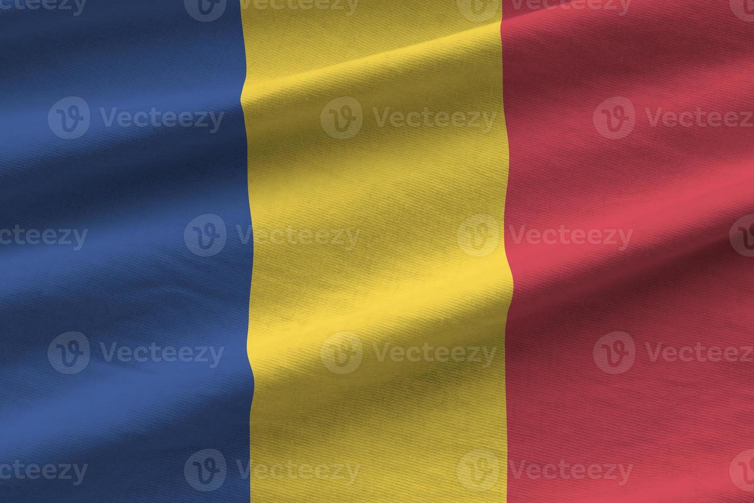 Romania bandiera con grande pieghe agitando vicino su sotto il studio leggero al chiuso. il ufficiale simboli e colori nel bandiera foto
