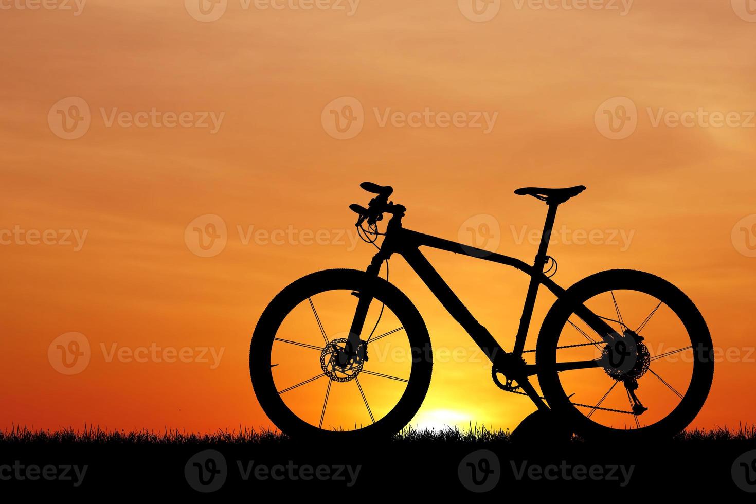silhouette di un' bicicletta su tramonto foto