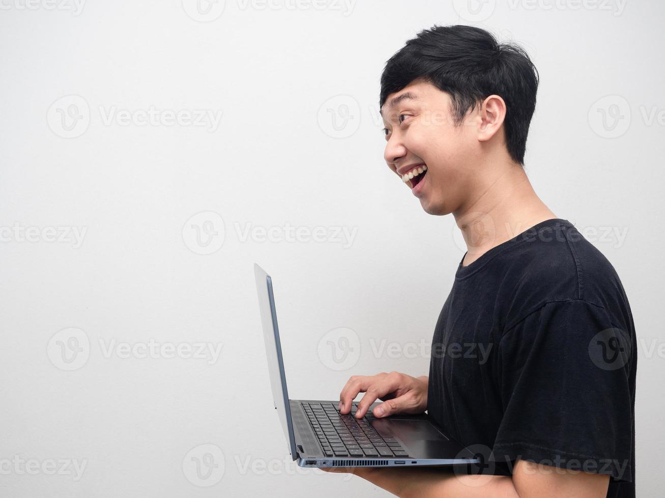 asiatico uomo sorridente e utilizzando il computer portatile lato Visualizza foto