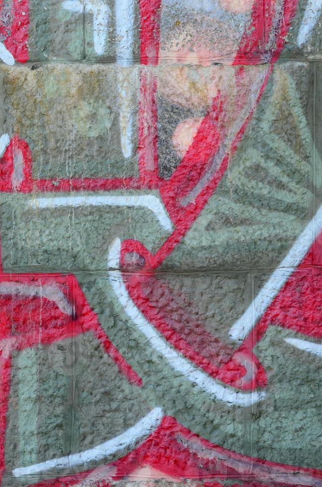 frammento di graffiti disegni. il vecchio parete decorato con dipingere macchie nel il stile di strada arte cultura. colorato sfondo struttura nel caldo toni foto