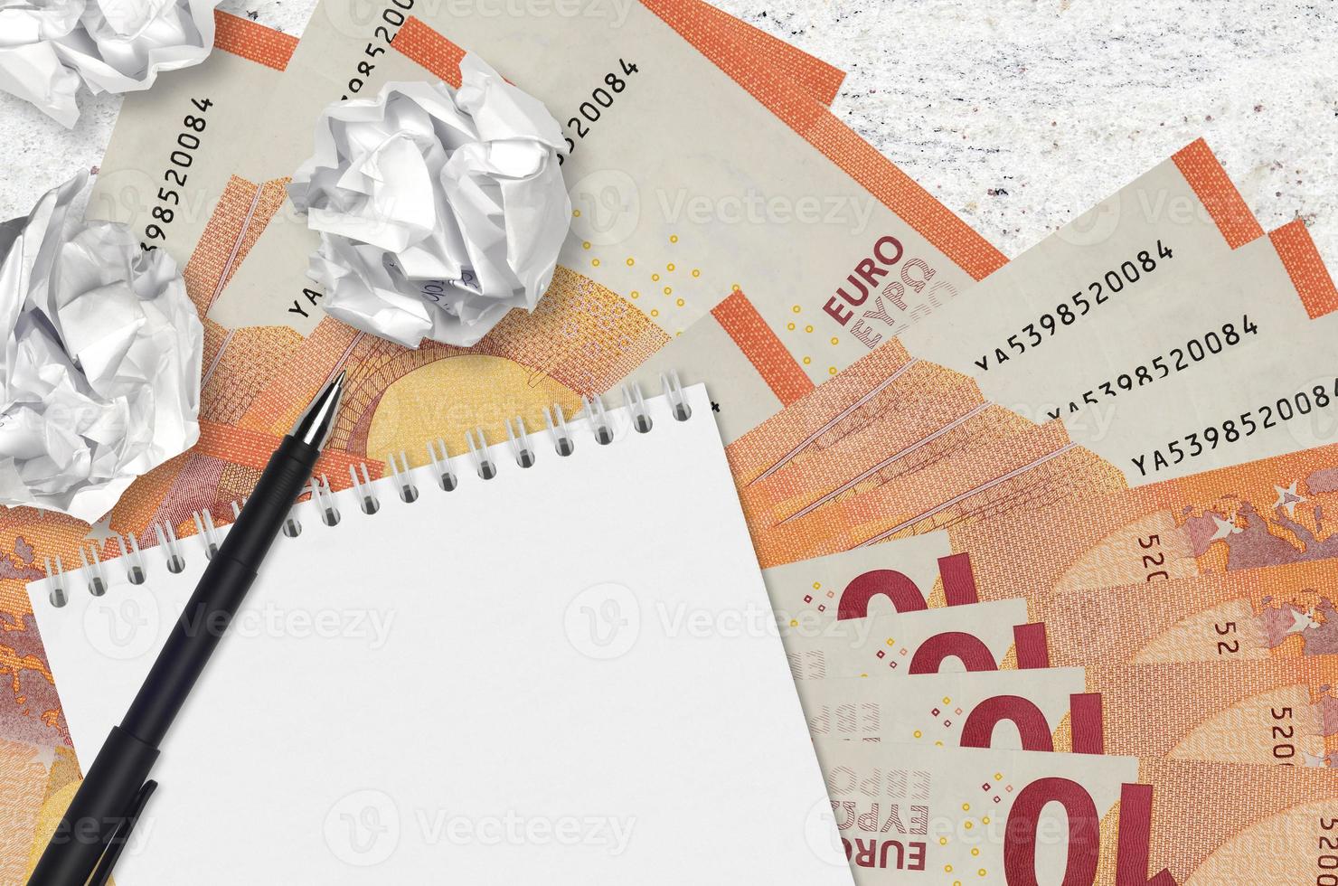 10 Euro fatture e palle di spiegazzato carta con vuoto bloc notes. cattivo idee o Di meno di ispirazione concetto. ricerca idee per investimento foto