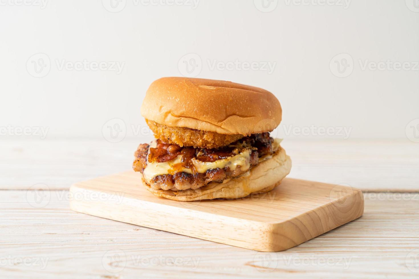 hamburger di maiale con formaggio, pancetta e anelli di cipolla foto