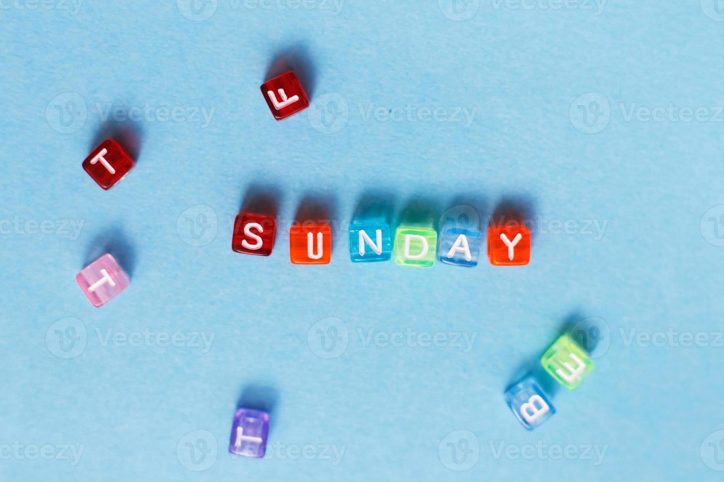 iscrizione Domenica fatto di multicolore plastica cubi su un' blu sfondo. foto