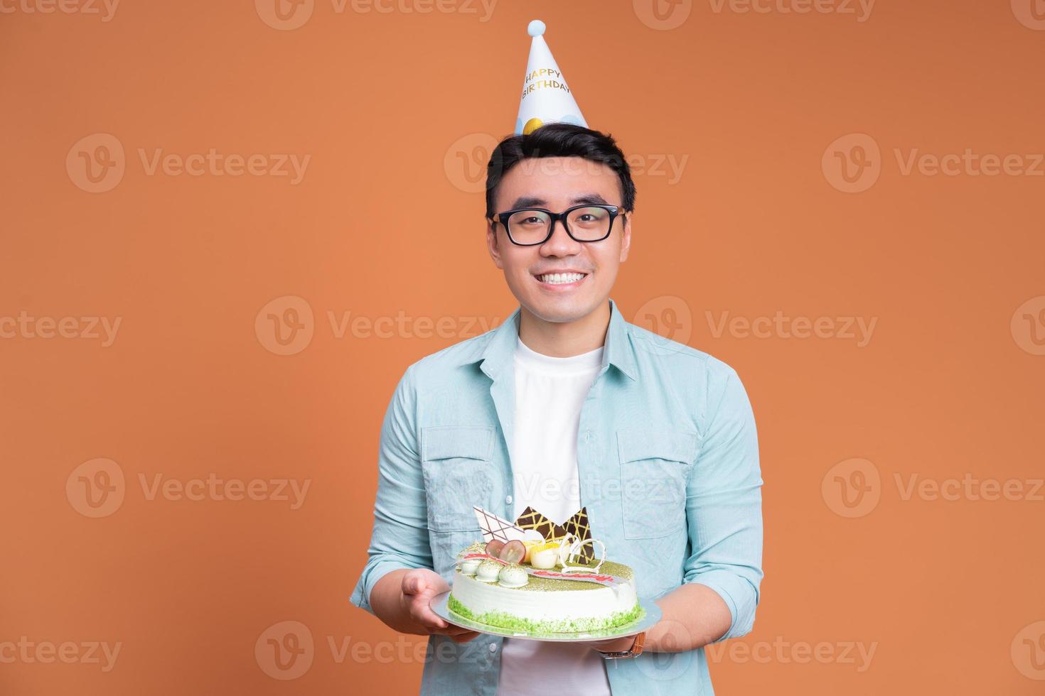 giovane asiatico uomo Tenere compleanno torta foto