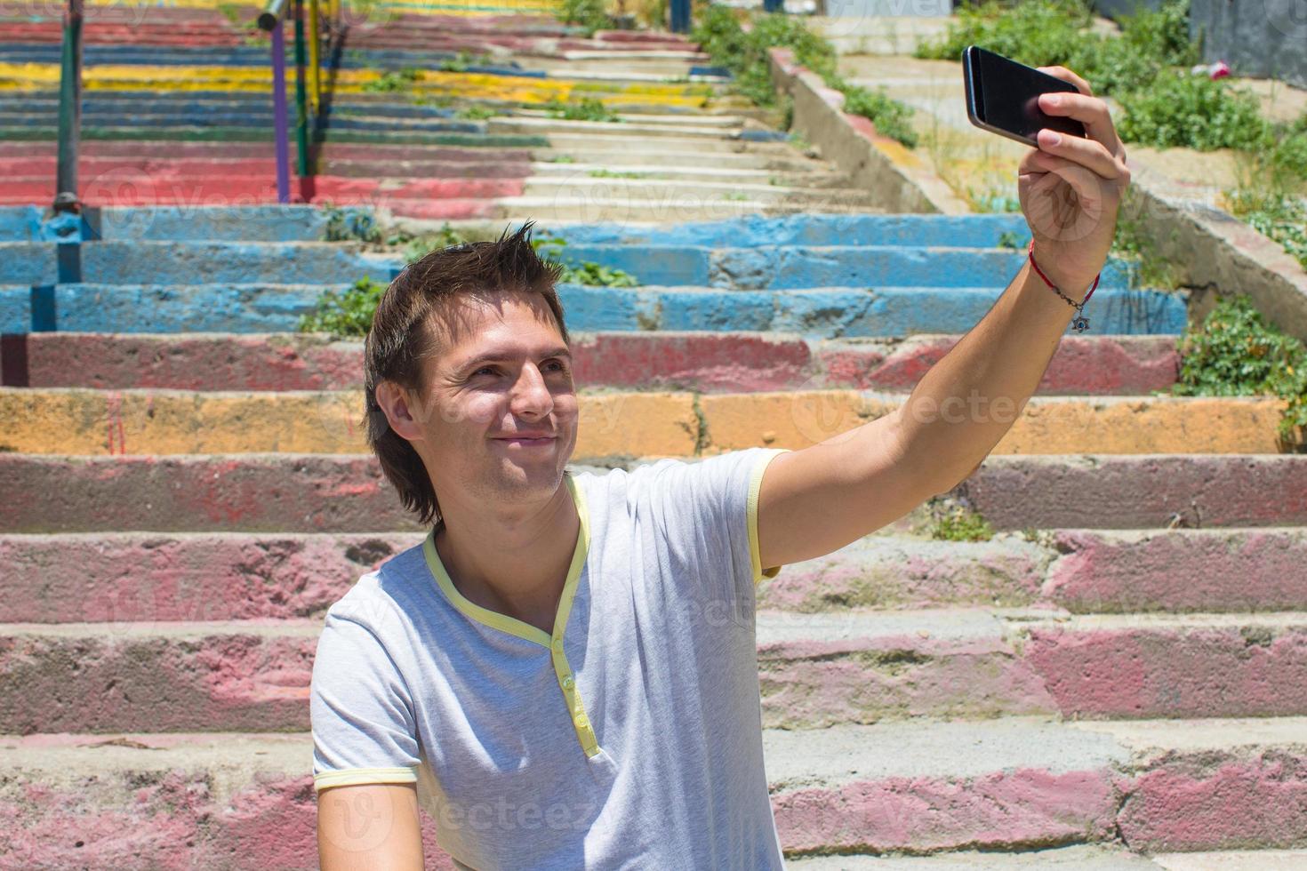 giovane uomo con cellulare nel vecchio scala foto