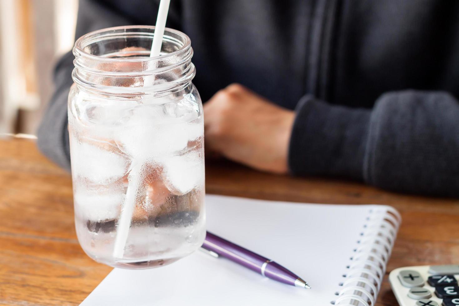 persona che tiene un bicchiere d'acqua in un barattolo foto