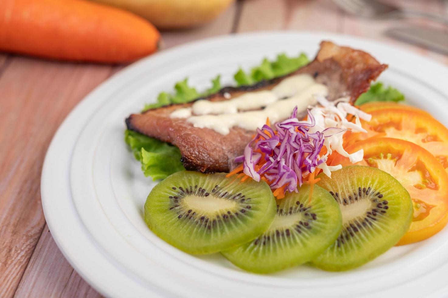 bistecca di pesce con patatine fritte e insalata foto