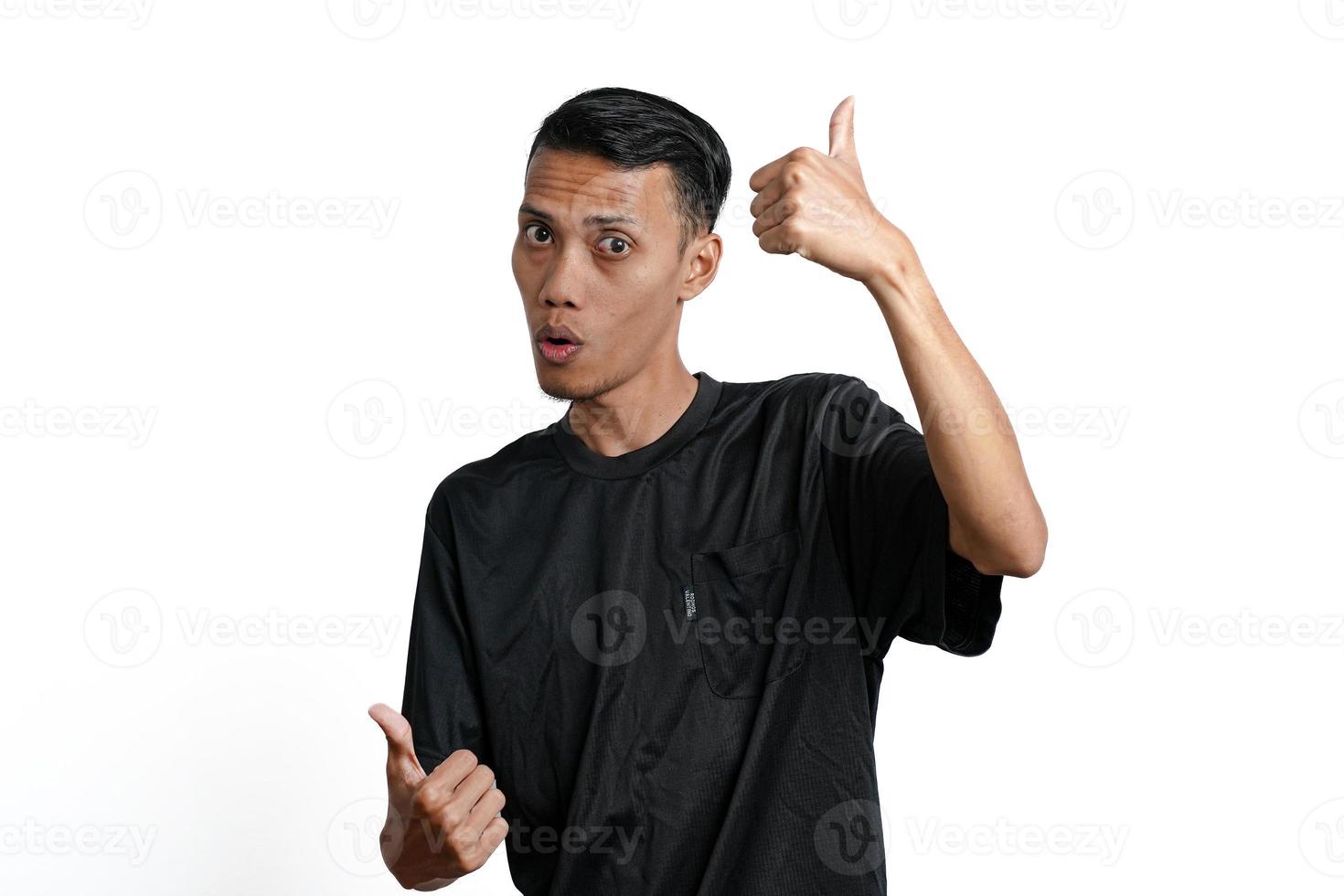 asiatico uomo indossare nero formazione maglietta, sensazione contento e dando pollici su. isolato di bianca sfondo foto