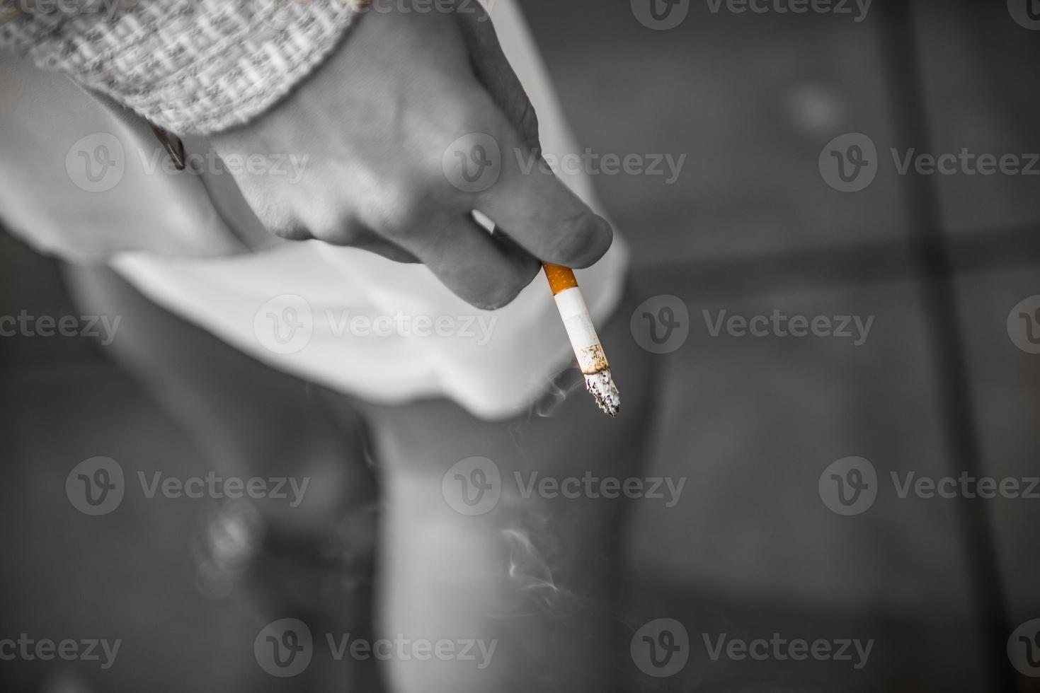 sigaretta nel il suo mano per un' donna foto