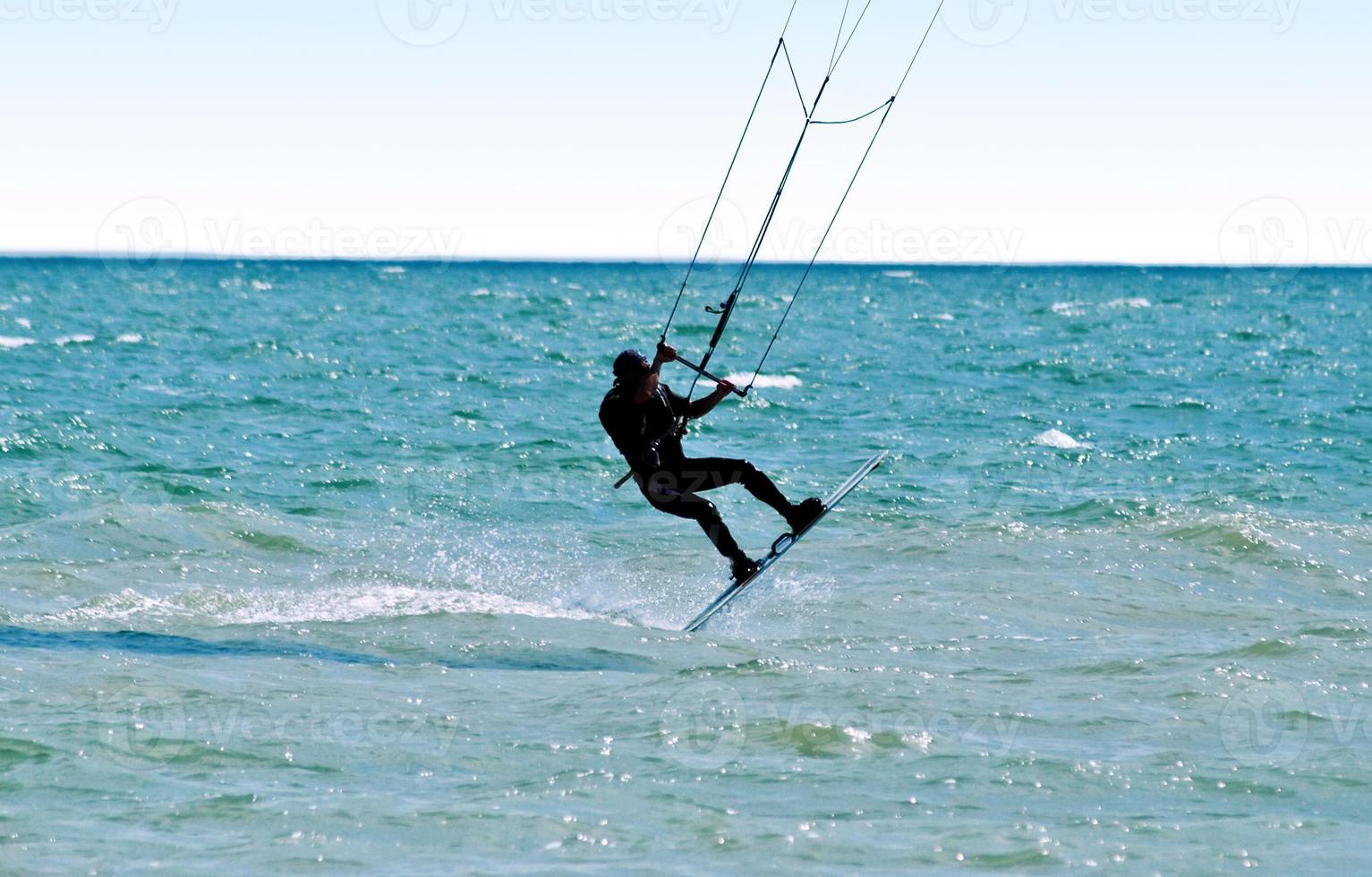 silhouette di un' kitesurfer su onde di un' mare foto